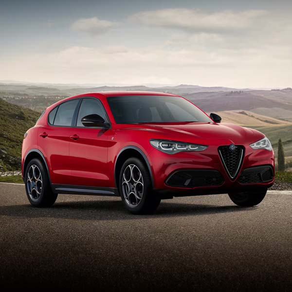 2025 Alfa Romeo Stelvio parked in front of a field.
