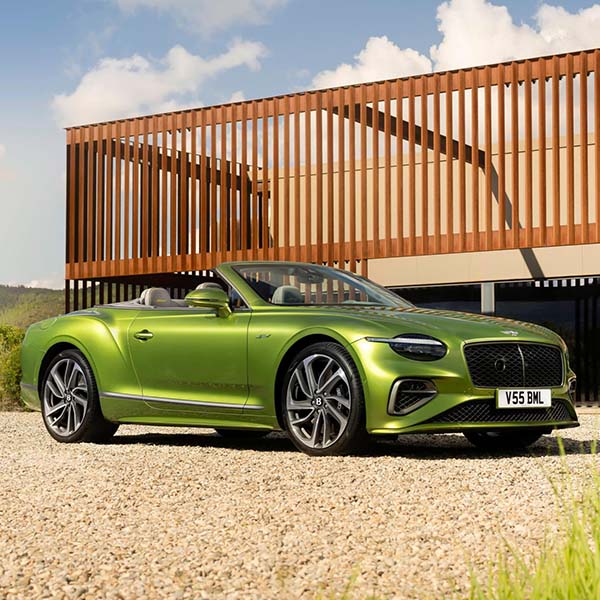 Exterior shot of a Bentley Continental GT Convertible parked in a driveway.