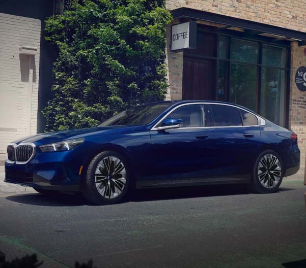 The 2026BMW 5 Series Sedan parked in an urban setting.