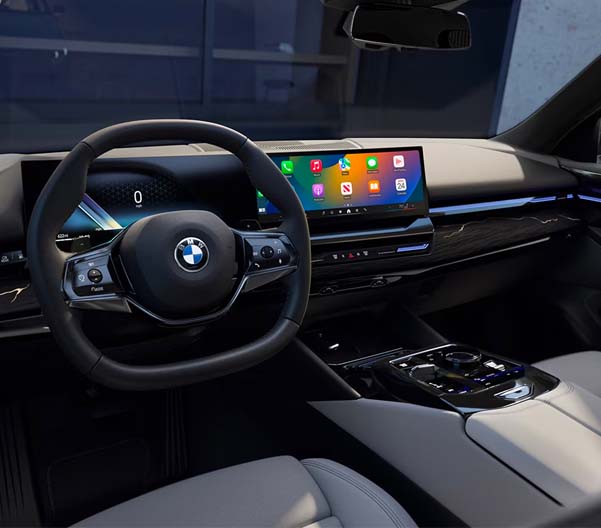 Close up of the BMW Curved display and steering wheel.