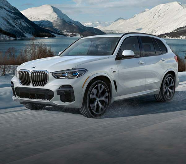 Exterior shot of a BMW driving in snow.