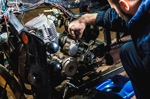 Mechanic working on a scooter.